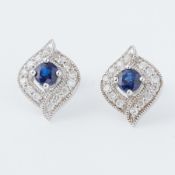 A pair of 9ct white gold earrings set with a central round cut sapphire, total sapphire weight