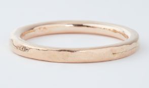 A 9ct rose gold hollow slave bangle, inner diameter approx. 6.5cm, outer diameter approx. 8cm, 18.