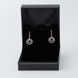 A pair of 18ct yellow & white gold circular design drop earrings each set with 0.25 carats of