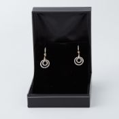 A pair of 18ct yellow & white gold circular design drop earrings each set with 0.25 carats of