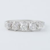 An antique platinum five stone ring set with five old cut diamonds, total diamond weight