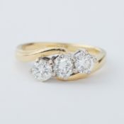 An 18ct yellow & white gold three stone twist ring set with three round brilliant cut diamonds,