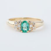 An 18ct yellow gold ring set with an oval cut emerald, approx. 0.42 carats, set with five small