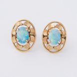 A pair of yellow gold (not hallmarked or tested) oval 'flower' style earrings set with a central