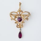 An antique 9ct yellow gold ornate pendant/brooch set with seed pearls (one missing) and purple
