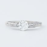 A platinum Art Deco ring set with a central round brilliant cut diamond, approx. 0.68 carats,