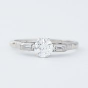 A platinum Art Deco ring set with a central round brilliant cut diamond, approx. 0.68 carats,