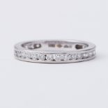 A platinum eternity style ring set with round brilliant cut diamonds which go 3/4 of the way