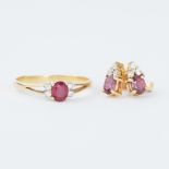 An 18ct yellow gold ring set with an oval cut ruby, approx. 0.32 carats with two small round
