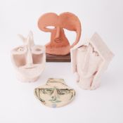 A group of four unglazed clay sculptures, abstract studies, tallest 26cm