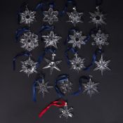 Swarovski Crystal Glass, a collection of sixteen Christmas star decorations including 1997, 1998,