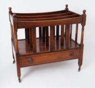 A reproduction mahogany canterbury, fitted with a single drawer on small castors.