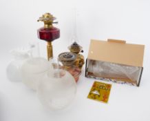 Victorian oil lamp with ruby glass reservoir and brass column together with two other oil lamps