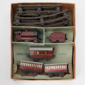 A Hornby O gauge tinplate and clockwork train set, LMS loco, tender, three coaches and track,