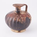 An Italian Apulian (Gnathian) black glazed terracotta flask, circa 330-300BC, height 14cm.