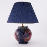 Moorcroft, a Moorcroft birds and fruit table lamp with shade.