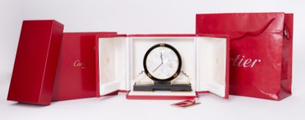 Cartier, a black onyx and mother of pearl Art Deco style Cartier clock with gilt detailing, the