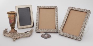 A mixed lot of silver items to include three photo frames, a small spill vase, a silver ornate