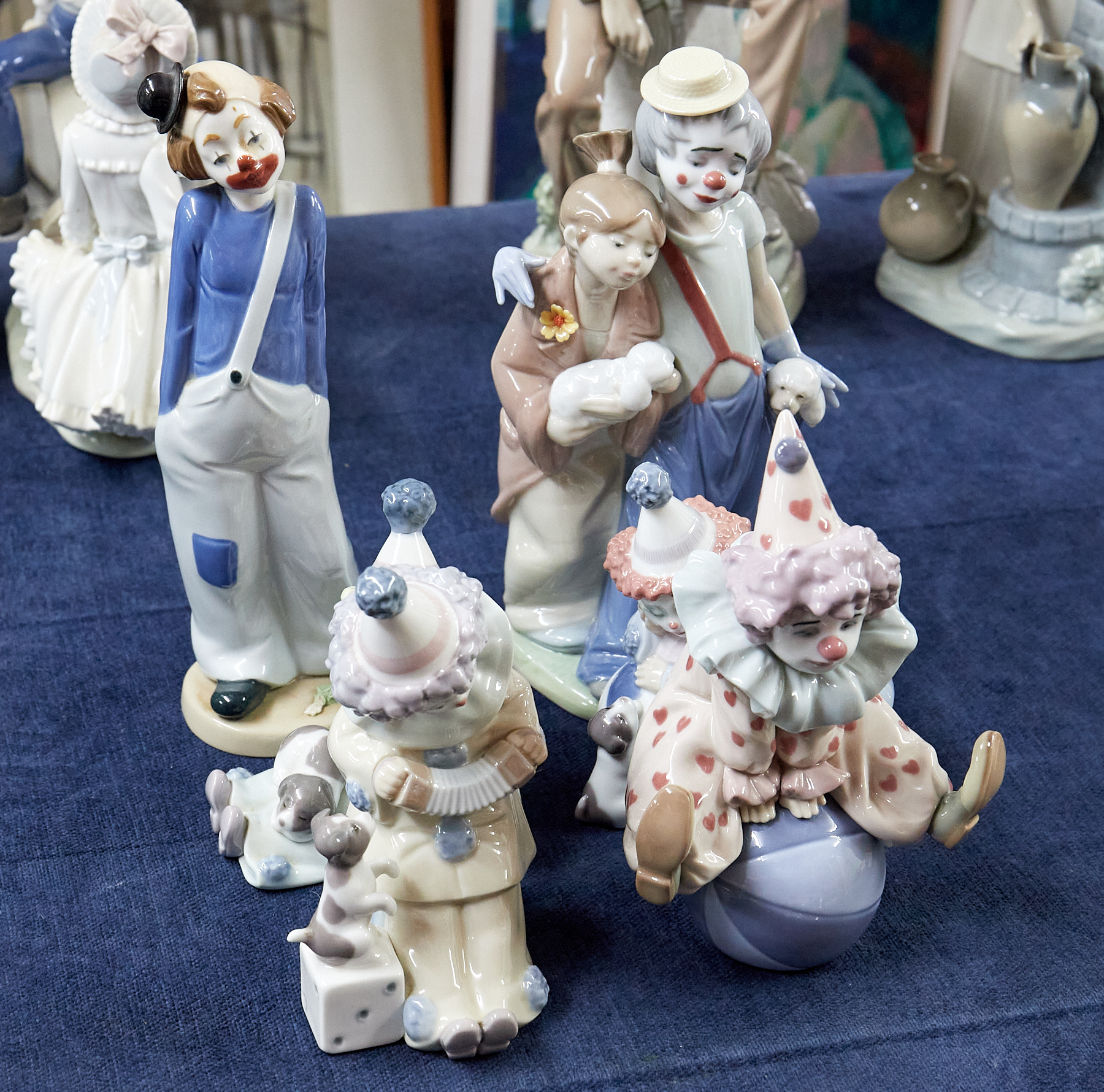 Six Lladro clown figurines.