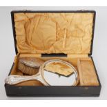 A boxed dressing table set comprising of ornate silver handled brush, mirror & two combs.