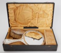 A boxed dressing table set comprising of ornate silver handled brush, mirror & two combs.