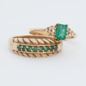 A 9ct yellow gold ring set with a central emerald cut emerald and a trefoil of small round cut