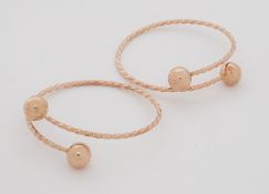 Two yellow gold (not hallmarked or tested) twist designed slave bangles with 'ball' ends, 26.