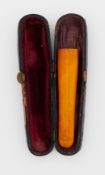 A cased amber cheroot.