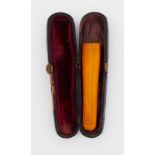 A cased amber cheroot.