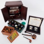 A vintage wood chess set, table display cabinet, set of V&A carpet bowls boxed and a gate stamp