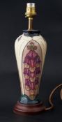 Moorcroft, table lamp on cream ground decorated with fox gloves, height 23cm together with shade.