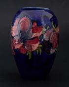 Moorcroft early vase signed WM, poppy's on blue ground, 18cm.