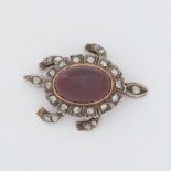 A Victorian articulated 'turtle' brooch set with old rough cut diamonds and a central cabochon cut