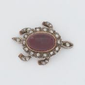 A Victorian articulated 'turtle' brooch set with old rough cut diamonds and a central cabochon cut