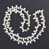 A 33" string of different shaped freshwater pearls ranging from white to pink in colour and strung