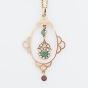 An antique yellow gold pendant set with seed pearls, two round cut emeralds and a round cut