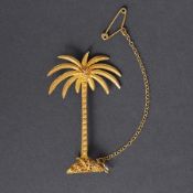 A yellow gold palm tree brooch with textured and embossed decoration & a safety chain, (not