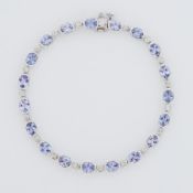 A 14k white gold line bracelet set with nineteen oval cut tanzanite's, total weight approx. 3.80