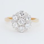 An 18ct yellow & white gold cluster ring set with round brilliant cut diamonds, total diamond weight