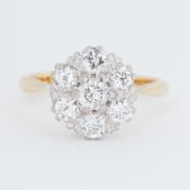 An 18ct yellow & white gold cluster ring set with round brilliant cut diamonds, total diamond weight