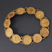 An Oriental 18ct yellow gold bracelet with ten round gold discs with applied Chinese symbols,