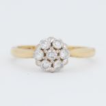 An 18ct yellow & white gold daisy ring set with round brilliant cut diamonds, total diamond weight