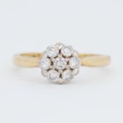 An 18ct yellow & white gold daisy ring set with round brilliant cut diamonds, total diamond weight