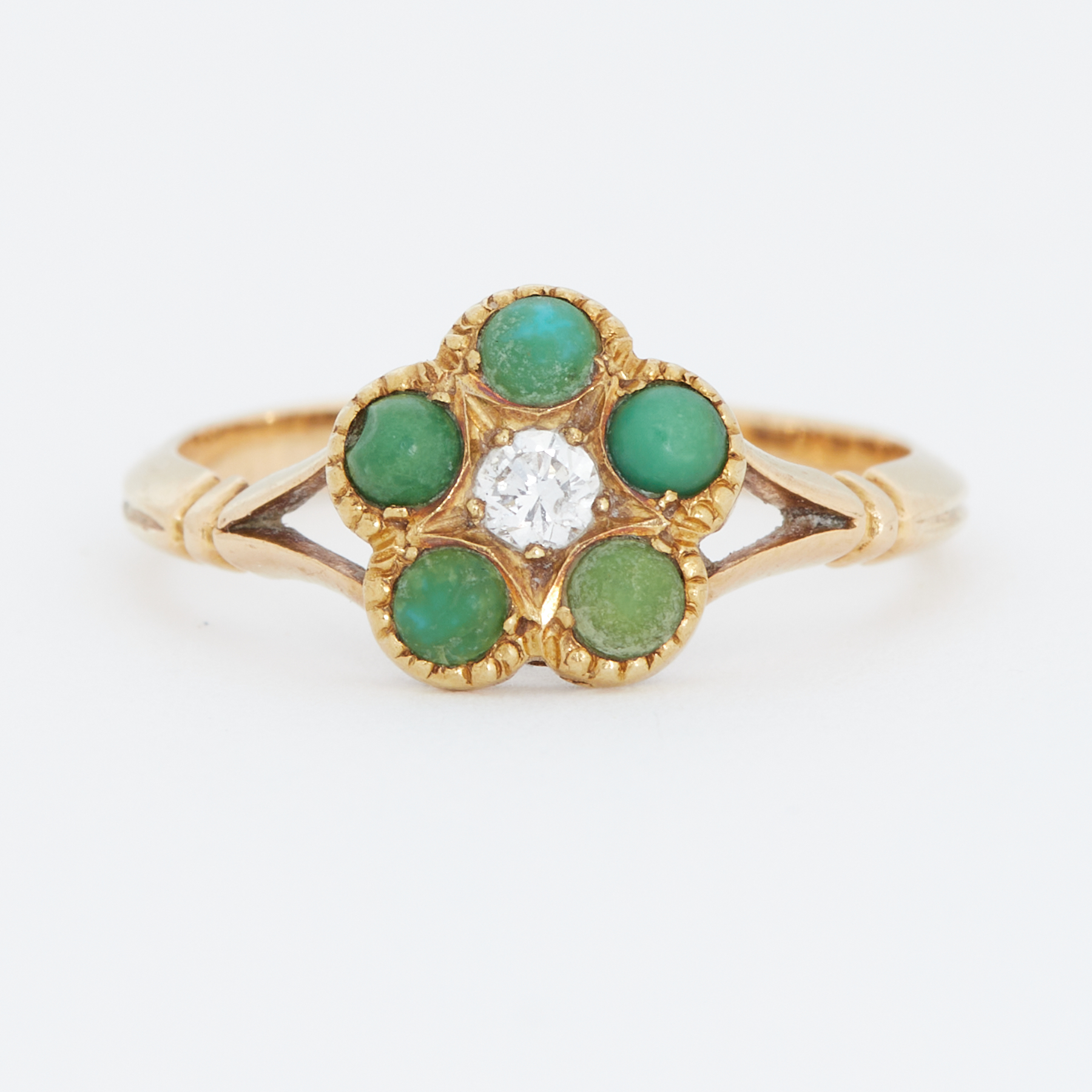 A yellow gold flower design ring set with a central old round cut diamond and surrounded by small