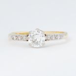 An 18ct yellow gold & platinum solitaire ring set with a central older round brilliant cut