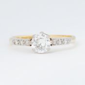 An 18ct yellow gold & platinum solitaire ring set with a central older round brilliant cut