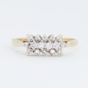 An 18ct yellow & white gold ring set with small round brilliant cut diamonds, total diamond weight