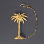 A yellow gold palm tree brooch with textured and embossed decoration & a safety chain, (not