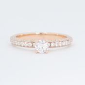 An 18ct rose gold ring set with a central round brilliant cut diamond, approx. 0.28 carats with
