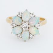 An 18ct yellow & white gold flower design cluster ring set with six oval cabochon cut opals,